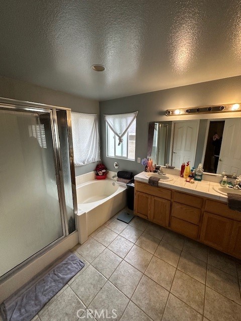 4485 Riverview Drive Riverside, CA 92509 - Photo 17 of 36 a large spacious bathroom with a double vanity sink a mirror and a bathtub