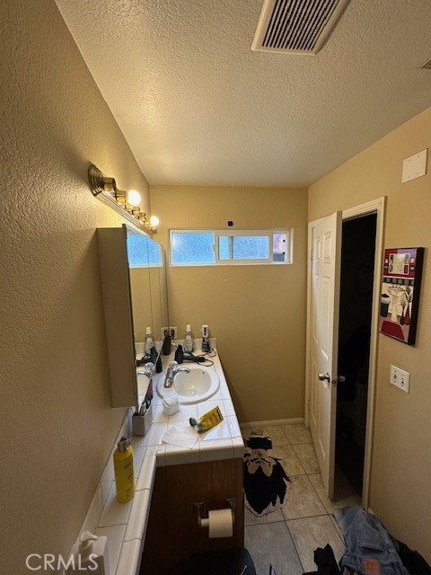 4485 Riverview Drive Riverside, CA 92509 - Photo 22 of 36 a bathroom with a sink toilet and shower