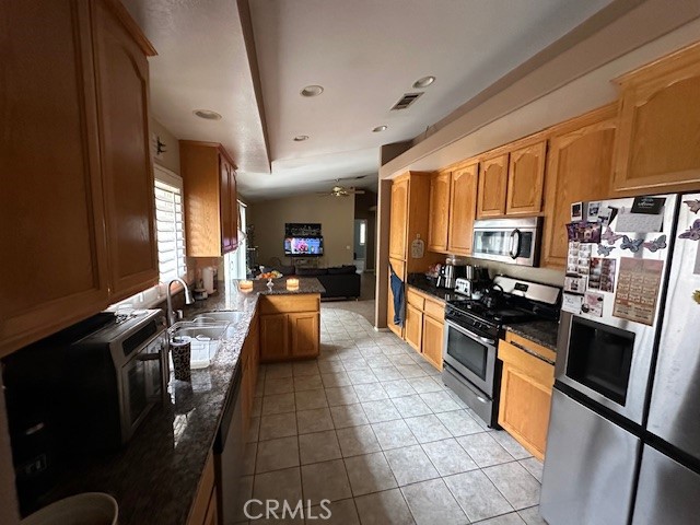 4485 Riverview Drive Riverside, CA 92509 - Photo 10 of 36 a large kitchen with stainless steel appliances granite countertop a stove refrigerator and a sink