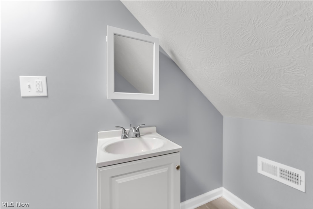 3925 Riverside Avenue Cleveland, OH 44109 - Photo 38 of 46 White vanity with an integrated sink and chrome faucet