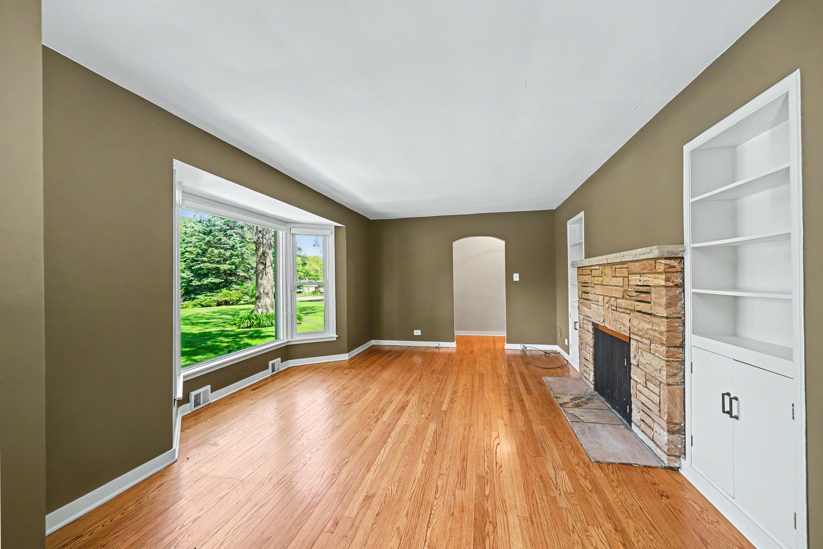 325 South Lambert Road Glen Ellyn, IL 60137 - Photo 11 of 32 a view of an empty room with a fireplace and a window