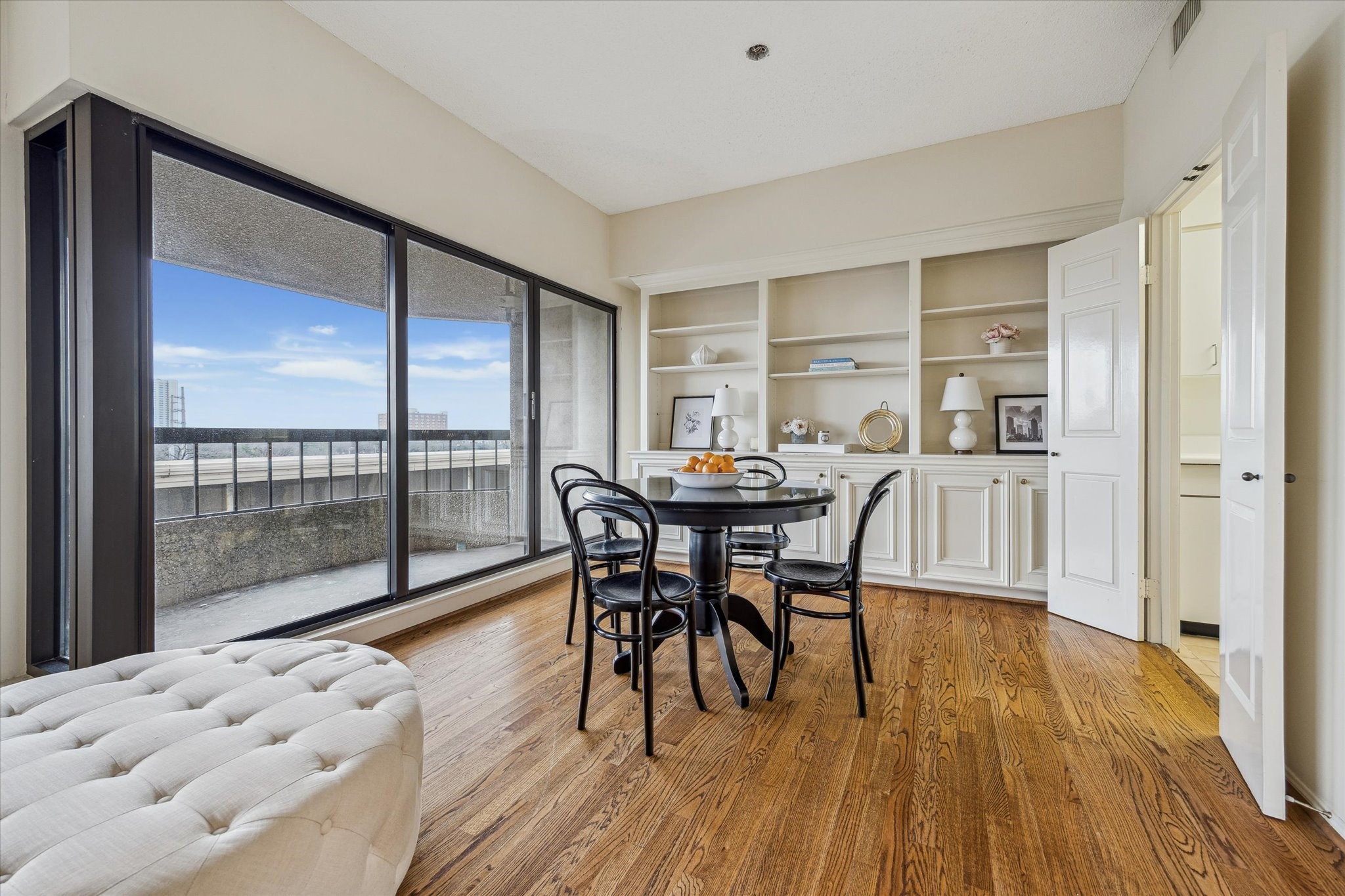 2001 Holcombe Boulevard, Unit 504 Houston, TX 77030 - Photo 7 of 38 Dining room with balcony access and a full wall of custom cabinetry.