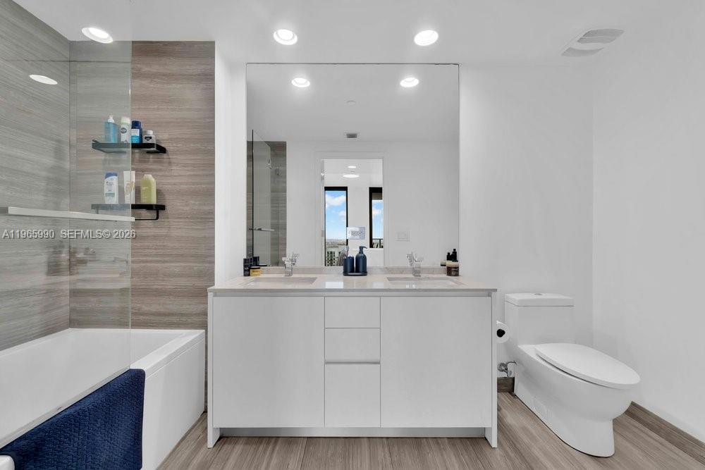 1010 Brickell Avenue, Unit 4011 Miami, FL 33131 - Photo 11 of 32 a bathroom with a sink a toilet and shower