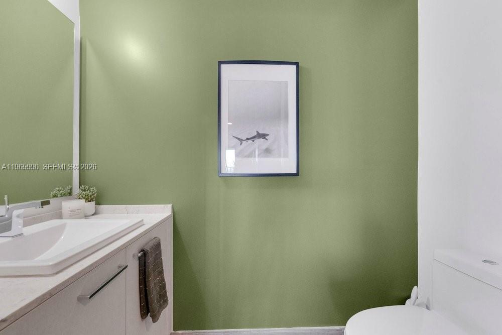 1010 Brickell Avenue, Unit 4011 Miami, FL 33131 - Photo 12 of 32 a bathroom with a sink and a toilet