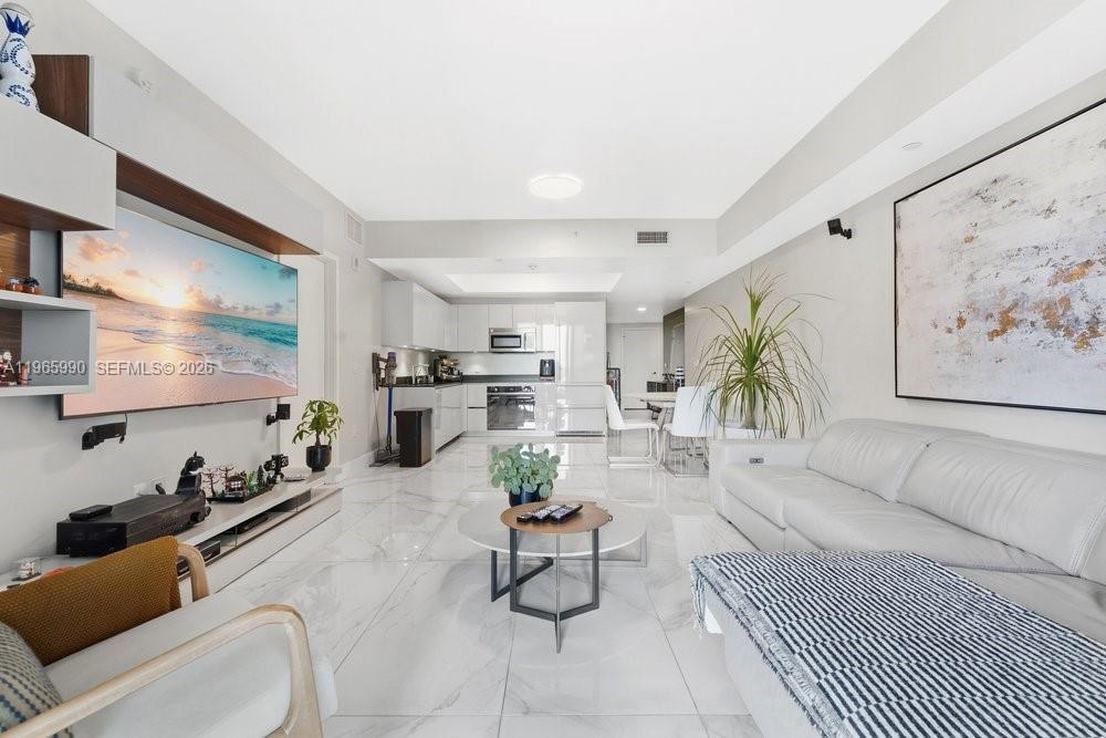 1010 Brickell Avenue, Unit 4011 Miami, FL 33131 - Photo 5 of 32 a living room with furniture and a flat screen tv