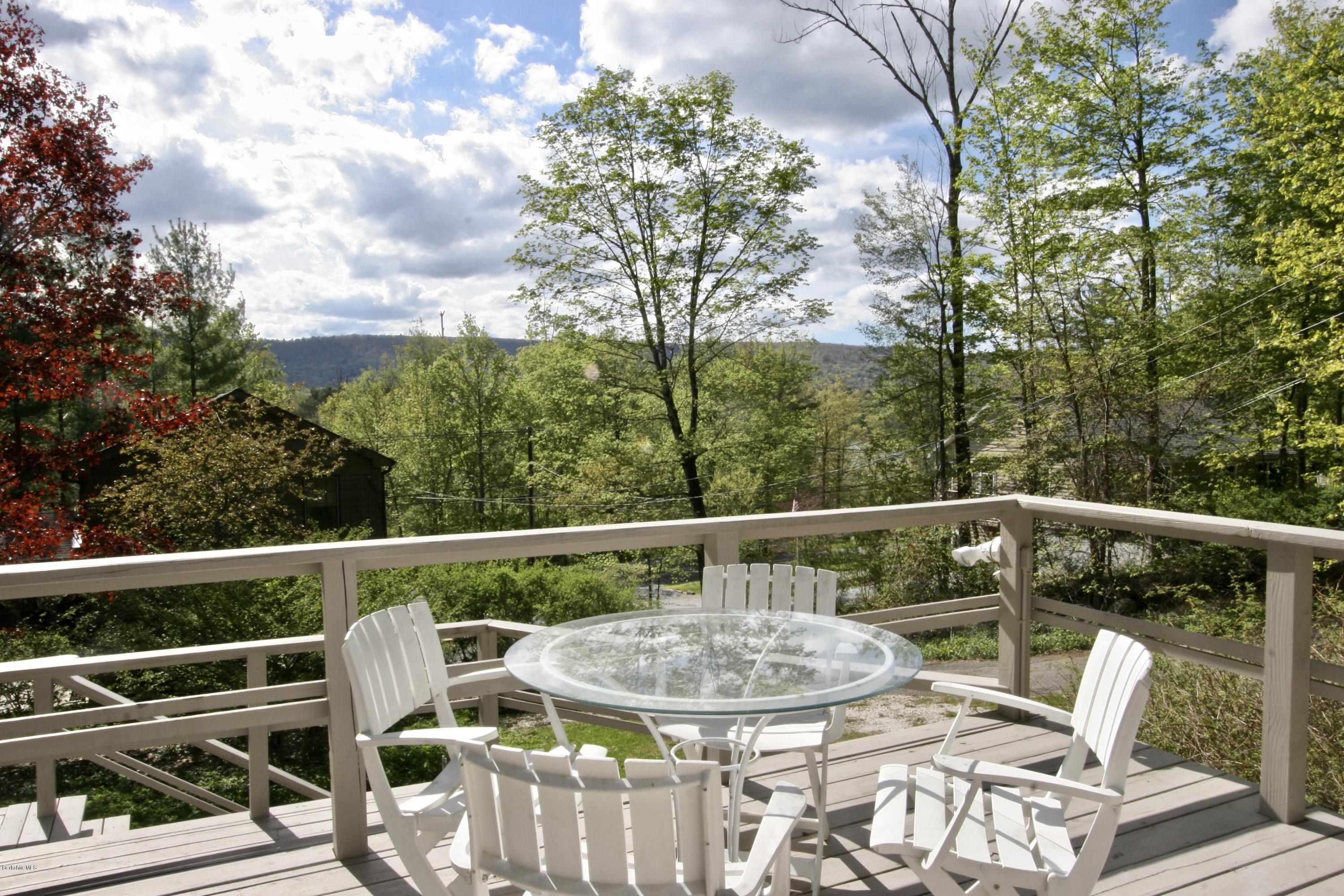 22 Mahkeenac Road Stockbridge, MA 01262 - Photo 5 of 24 a view of a chairs and table on the deck