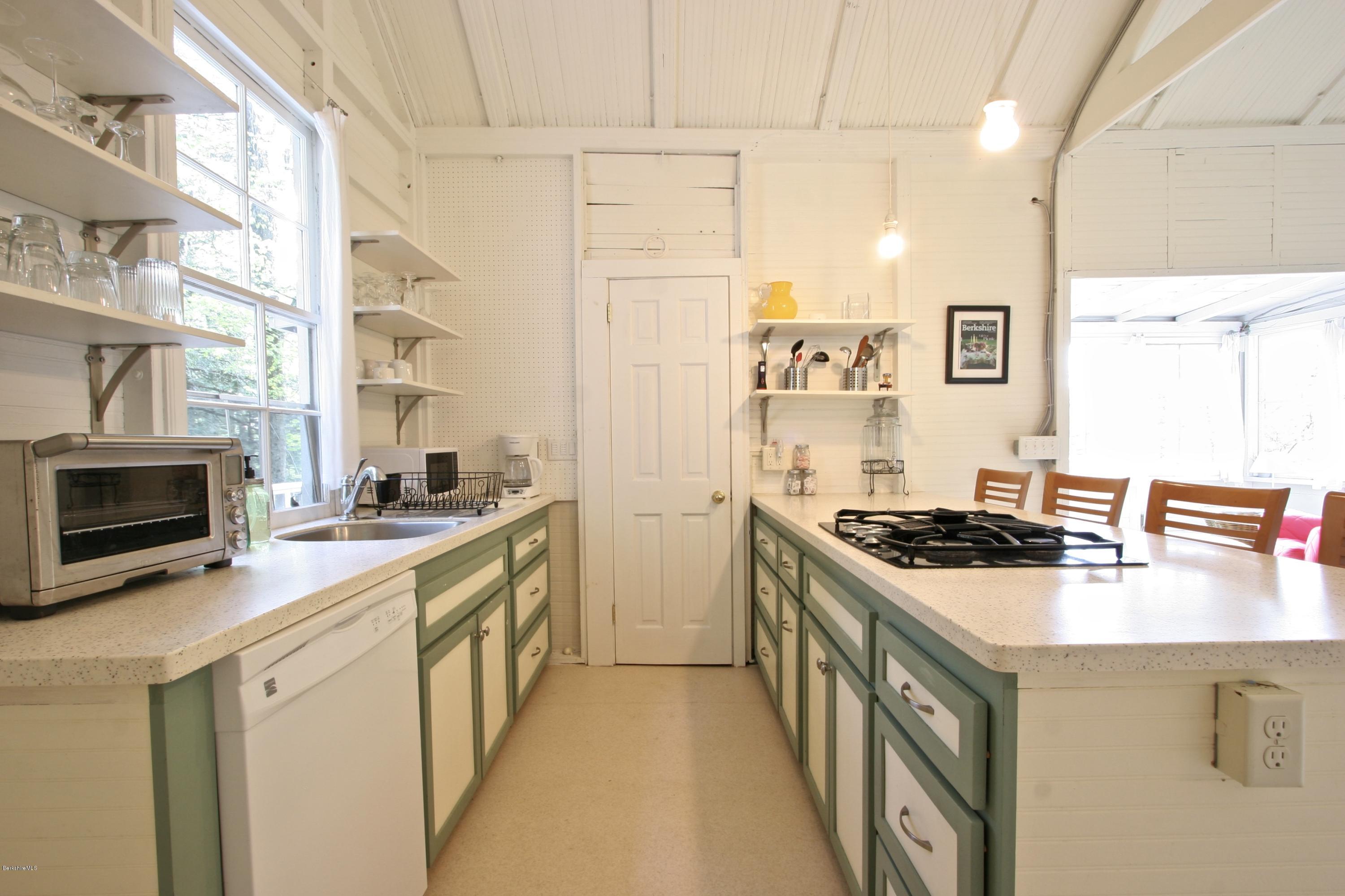 22 Mahkeenac Road Stockbridge, MA 01262 - Photo 7 of 24 a kitchen with stainless steel appliances a stove a sink a microwave and a refrigerator