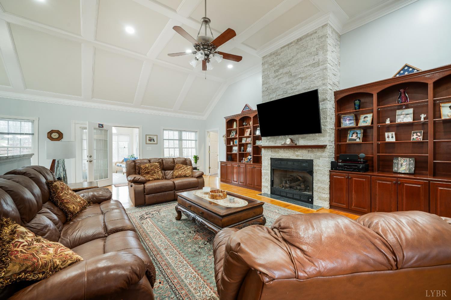 378 Tusculum Lane East Amherst, VA 24521 - Photo 23 of 99 a living room with furniture a fireplace and a flat screen tv