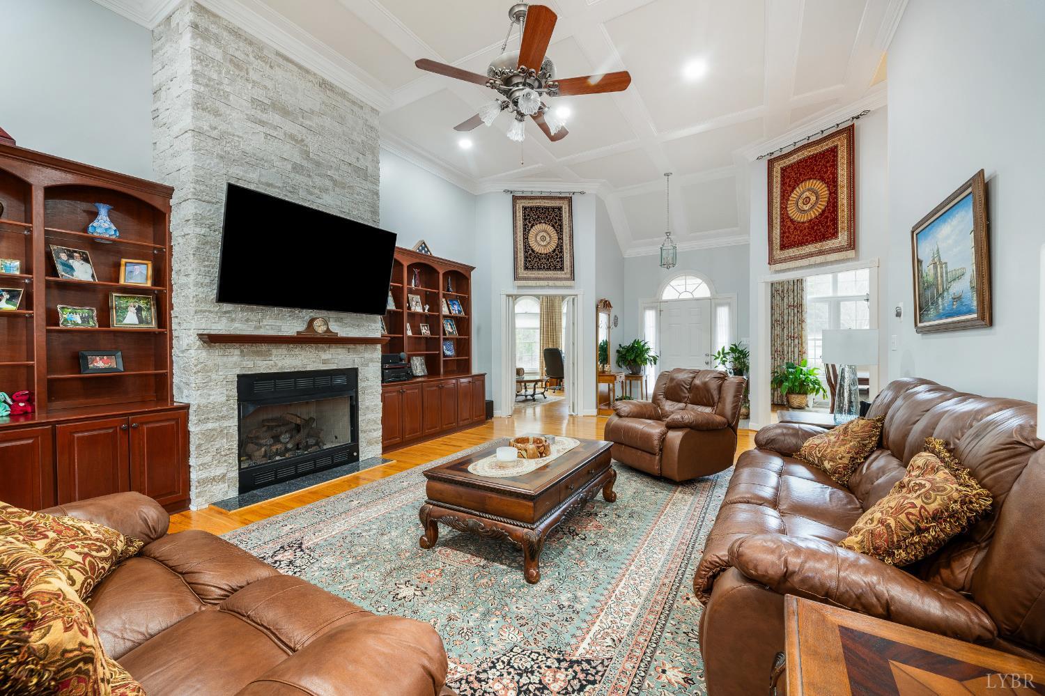 378 Tusculum Lane East Amherst, VA 24521 - Photo 25 of 99 a living room with furniture a flat screen tv and a fireplace