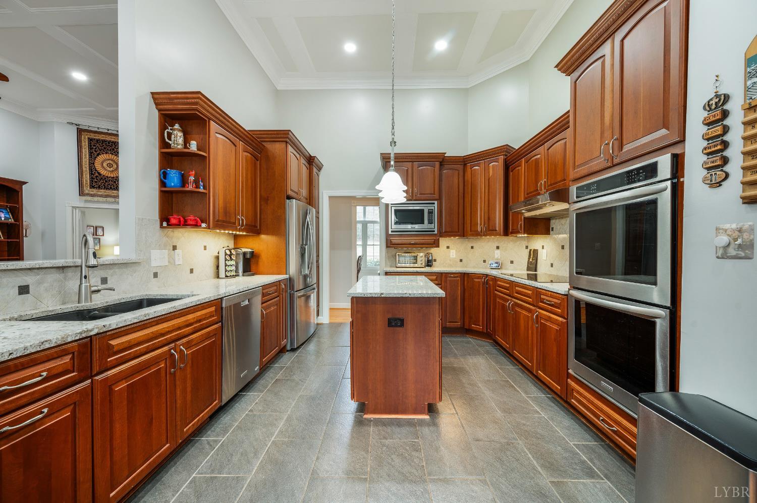 378 Tusculum Lane East Amherst, VA 24521 - Photo 27 of 99 a large kitchen with stainless steel appliances wooden cabinets a sink and a stove