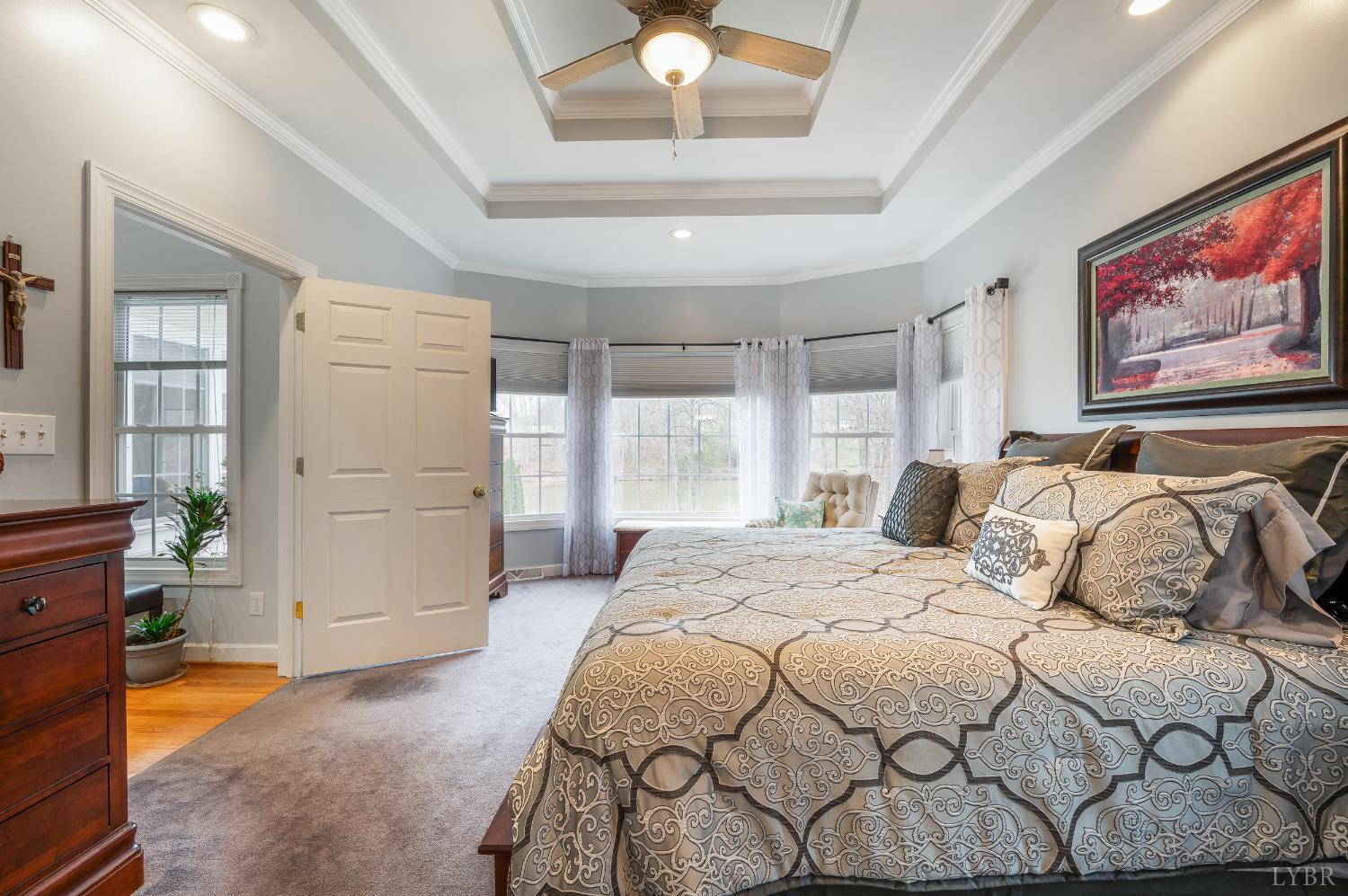 378 Tusculum Lane East Amherst, VA 24521 - Photo 39 of 99 a bedroom with a bed and a chandelier