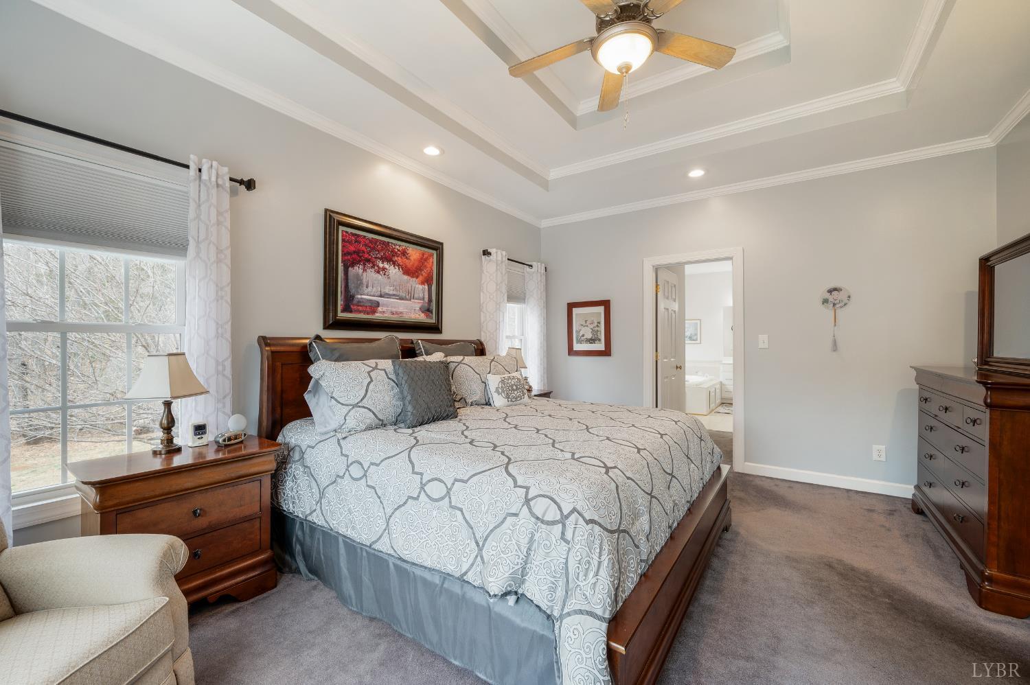 378 Tusculum Lane East Amherst, VA 24521 - Photo 40 of 99 a bedroom with a bed and a chandelier