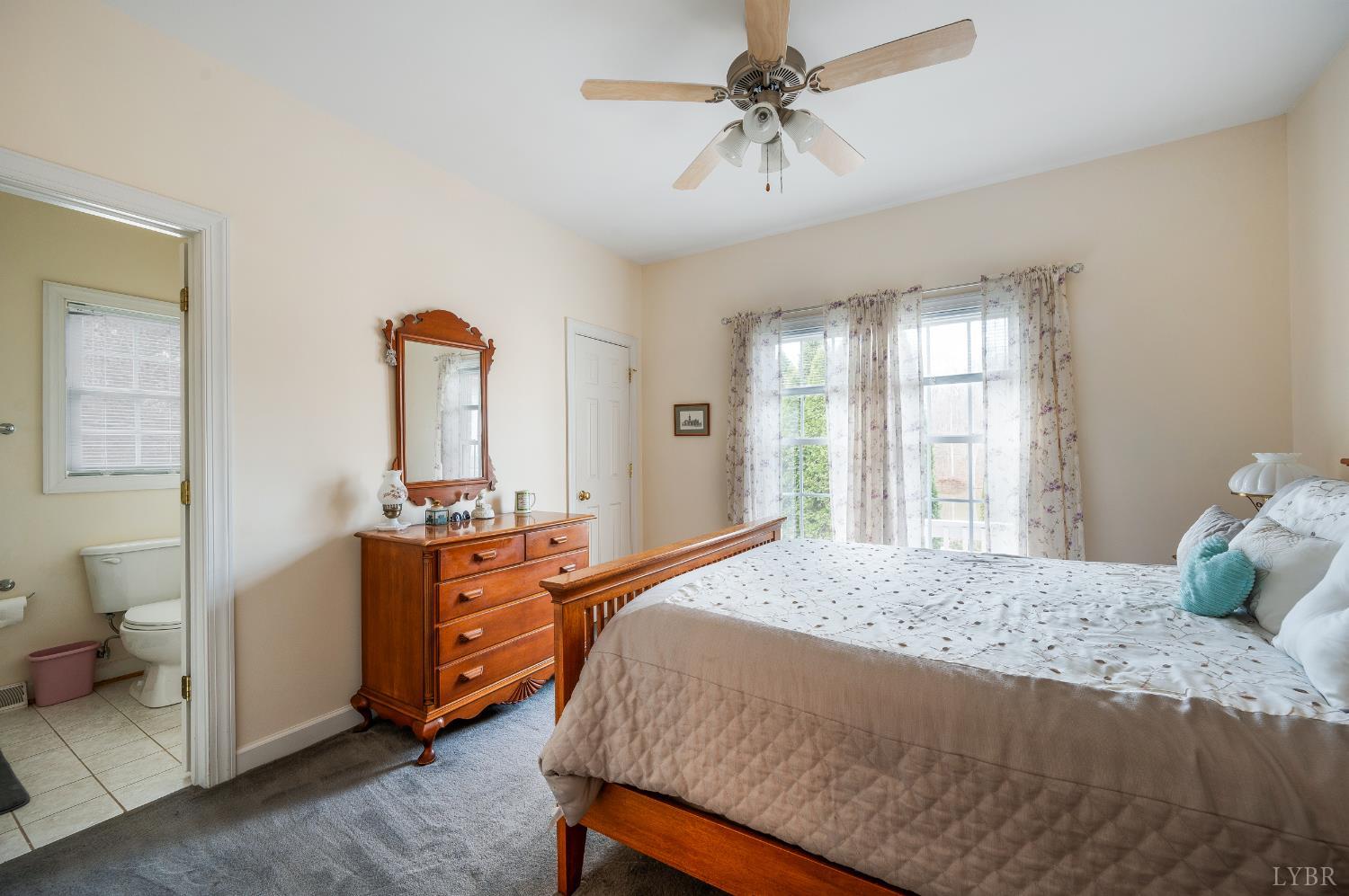 378 Tusculum Lane East Amherst, VA 24521 - Photo 47 of 99 a bedroom with a bed and a chandelier