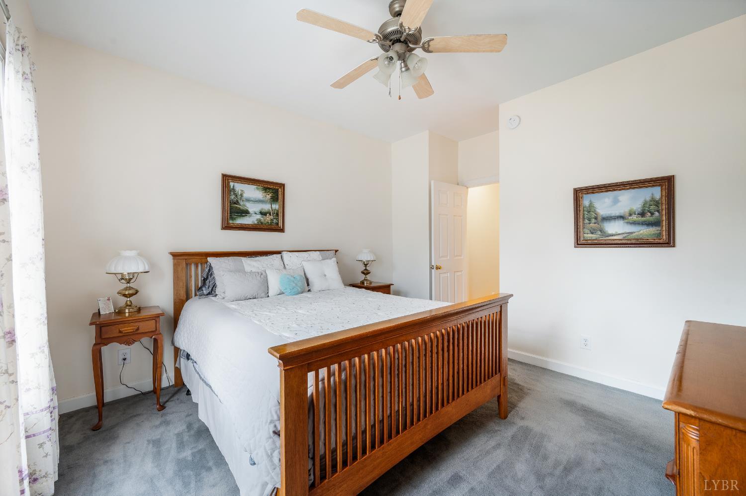 378 Tusculum Lane East Amherst, VA 24521 - Photo 48 of 99 a bedroom with a bed and a chandelier