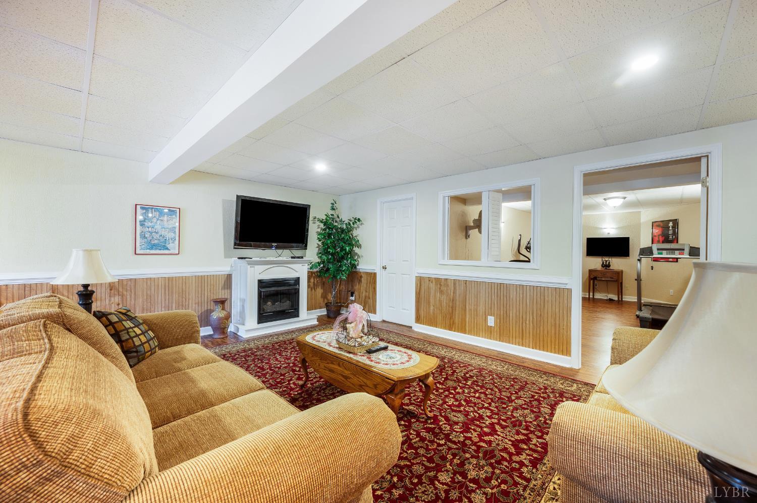 378 Tusculum Lane East Amherst, VA 24521 - Photo 67 of 99 a living room with furniture and a flat screen tv