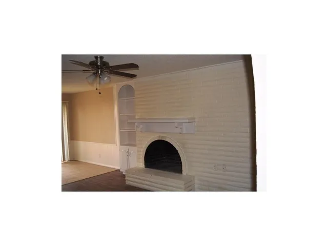 a black and white building with wooden floor