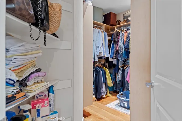 a view of walk in closet with clothes