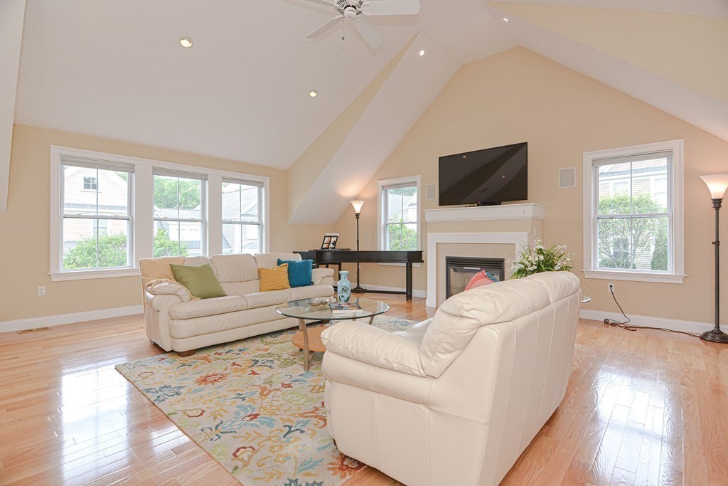 159 Prospect Street, Unit 7 Acton, MA 01720 - Photo 14 of 31 a living room with furniture a fireplace and a flat screen tv