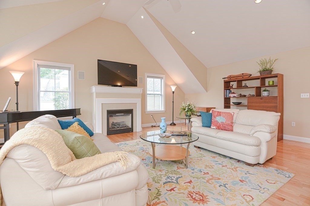 159 Prospect Street, Unit 7 Acton, MA 01720 - Photo 15 of 31 a living room with furniture a flat screen tv and a fireplace