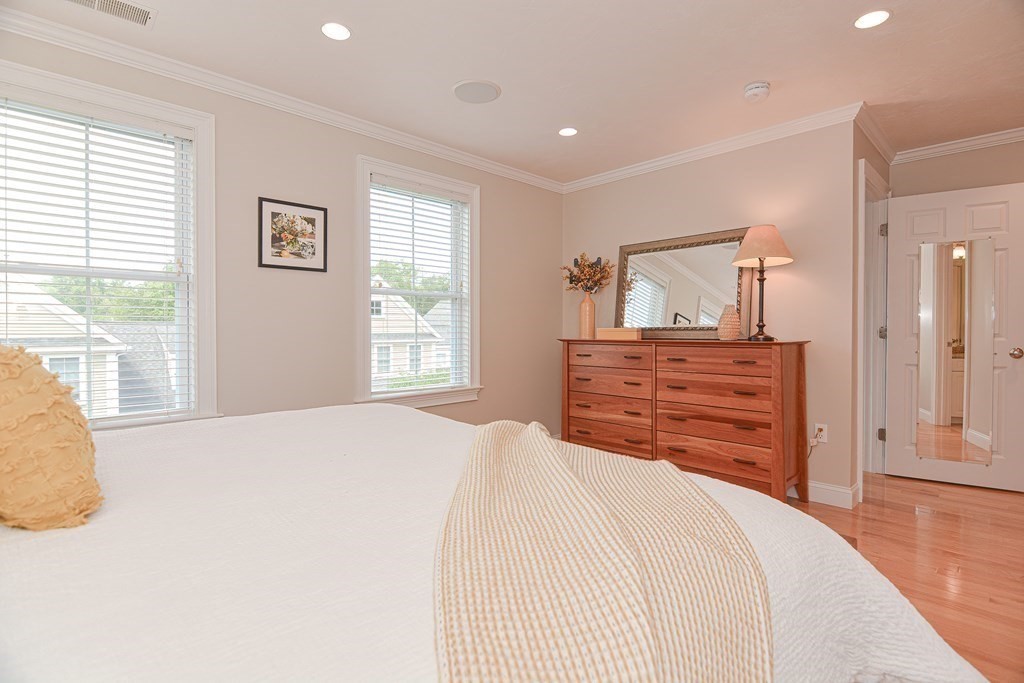 159 Prospect Street, Unit 7 Acton, MA 01720 - Photo 17 of 31 a bedroom with a bed and a dresser
