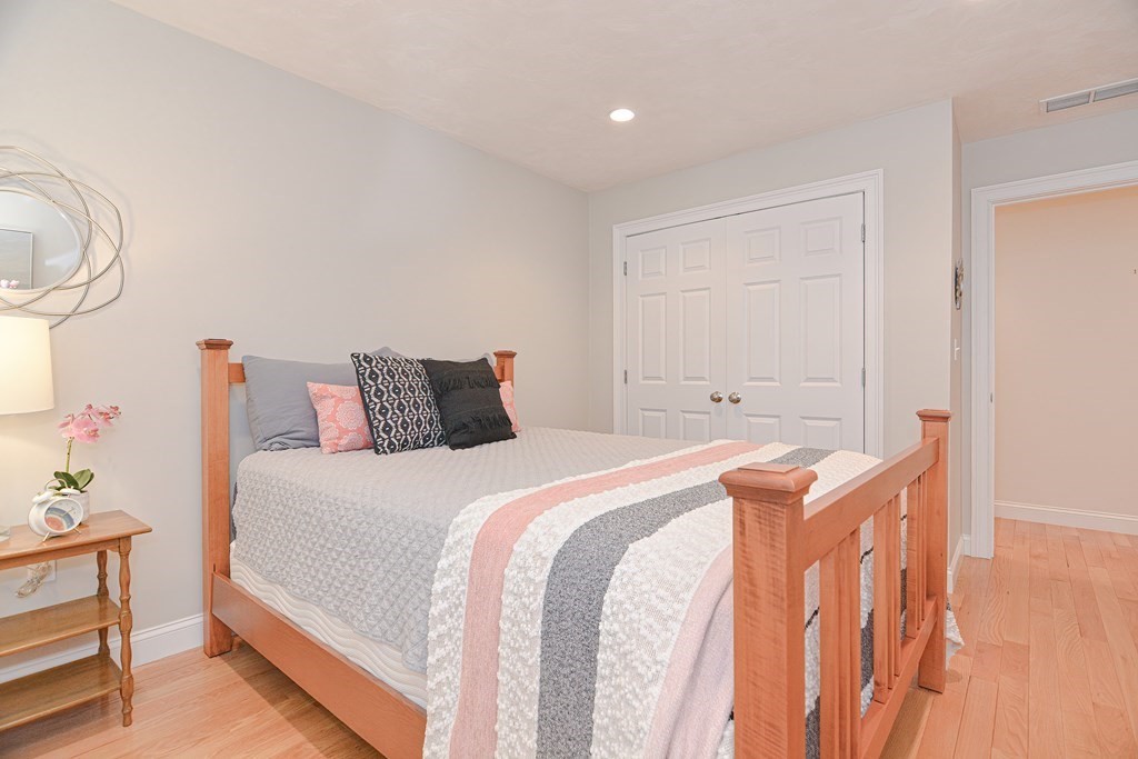 159 Prospect Street, Unit 7 Acton, MA 01720 - Photo 20 of 31 a bedroom with a bed and a chandelier