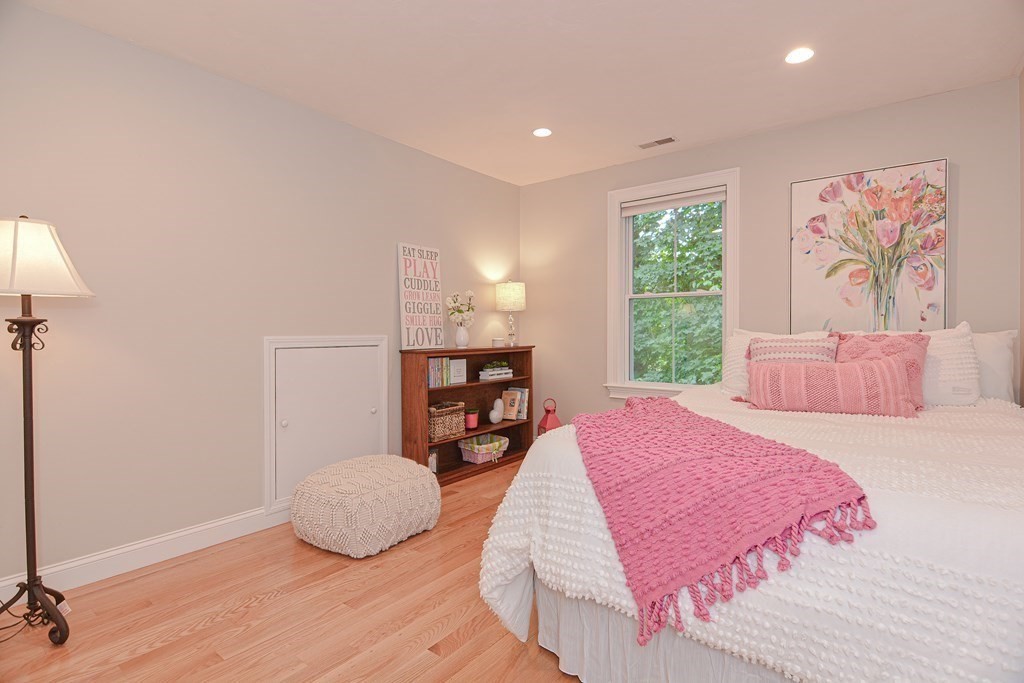 159 Prospect Street, Unit 7 Acton, MA 01720 - Photo 22 of 31 a bedroom with a bed and wooden floor