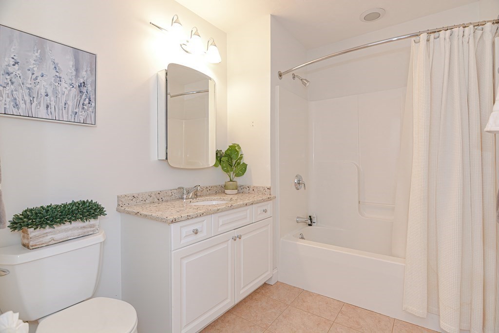 159 Prospect Street, Unit 7 Acton, MA 01720 - Photo 23 of 31 a bathroom with a granite countertop sink and a mirror