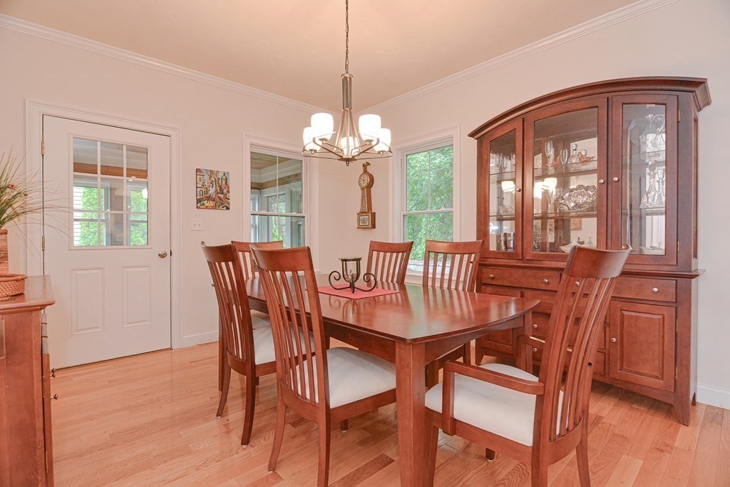 159 Prospect Street, Unit 7 Acton, MA 01720 - Photo 9 of 31 a view of a dining room with furniture wooden floor and chandelier
