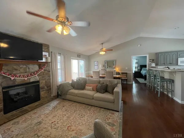 a room with furniture and view of kitchen
