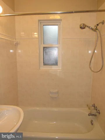 a bathroom with a bathtub and shower