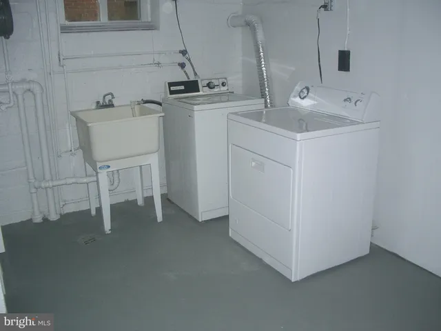 a kitchen with sink and white cabinets