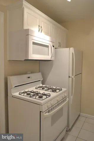 a white refrigerator freezer sitting inside of a kitchen
