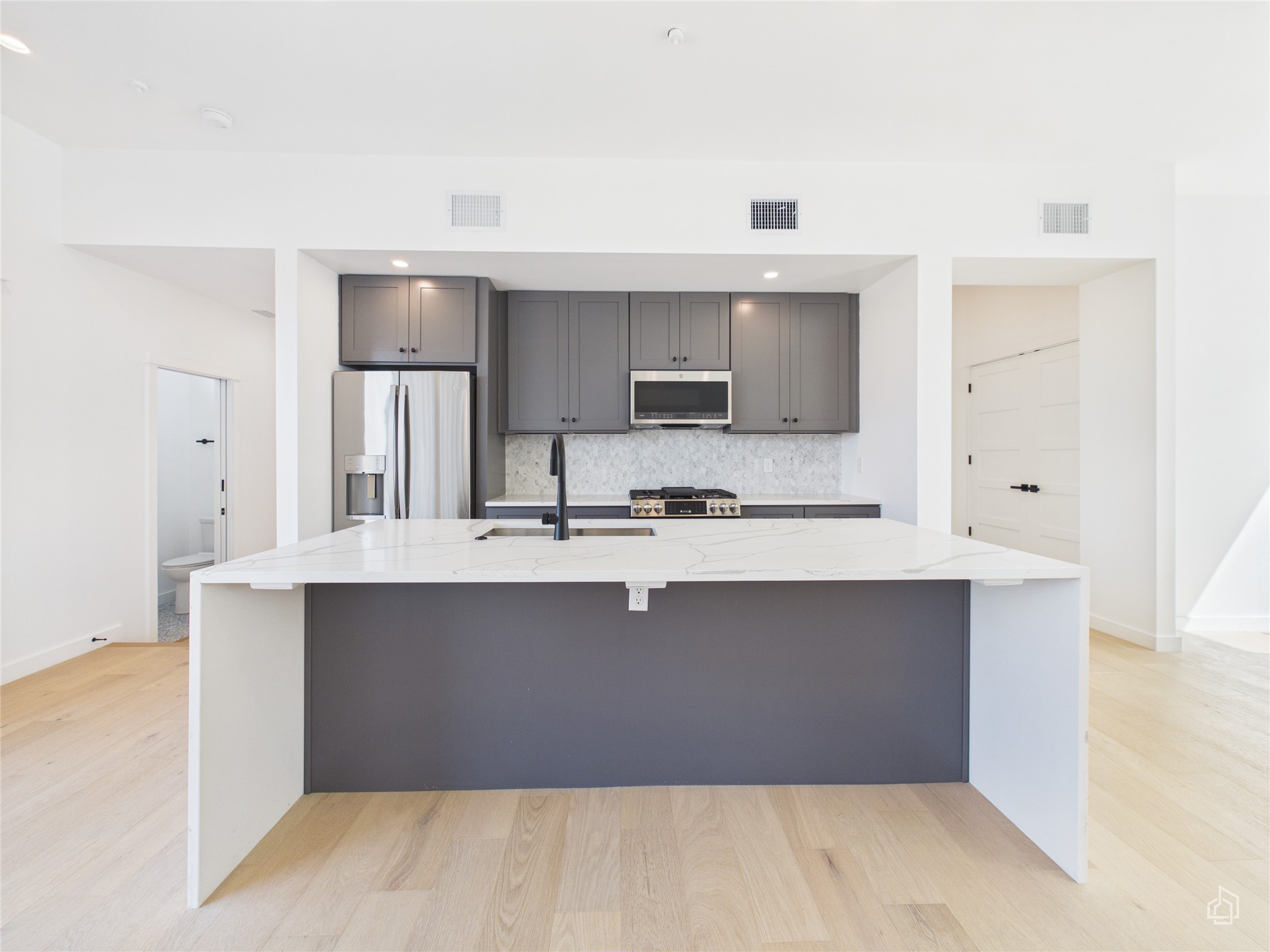 5912 Harold Court, Unit 105 Austin, TX 78721 - Photo 13 of 32 a kitchen with stainless steel appliances a sink stove and cabinets