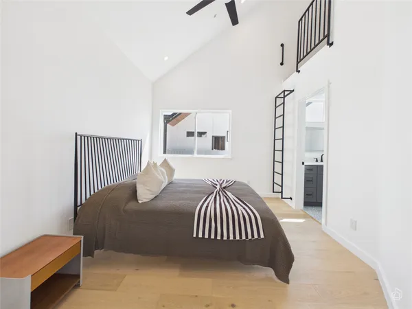 a bedroom with a bed and wooden floor