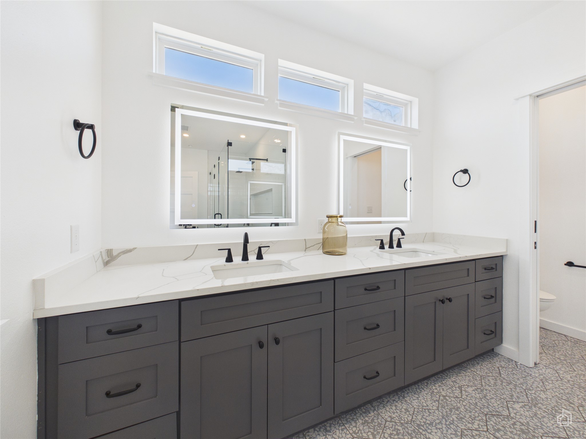 5912 Harold Court, Unit 105 Austin, TX 78721 - Photo 26 of 32 a bathroom with a double vanity sink and mirror