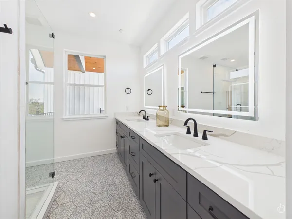 a bathroom with a sink double vanity and a mirror
