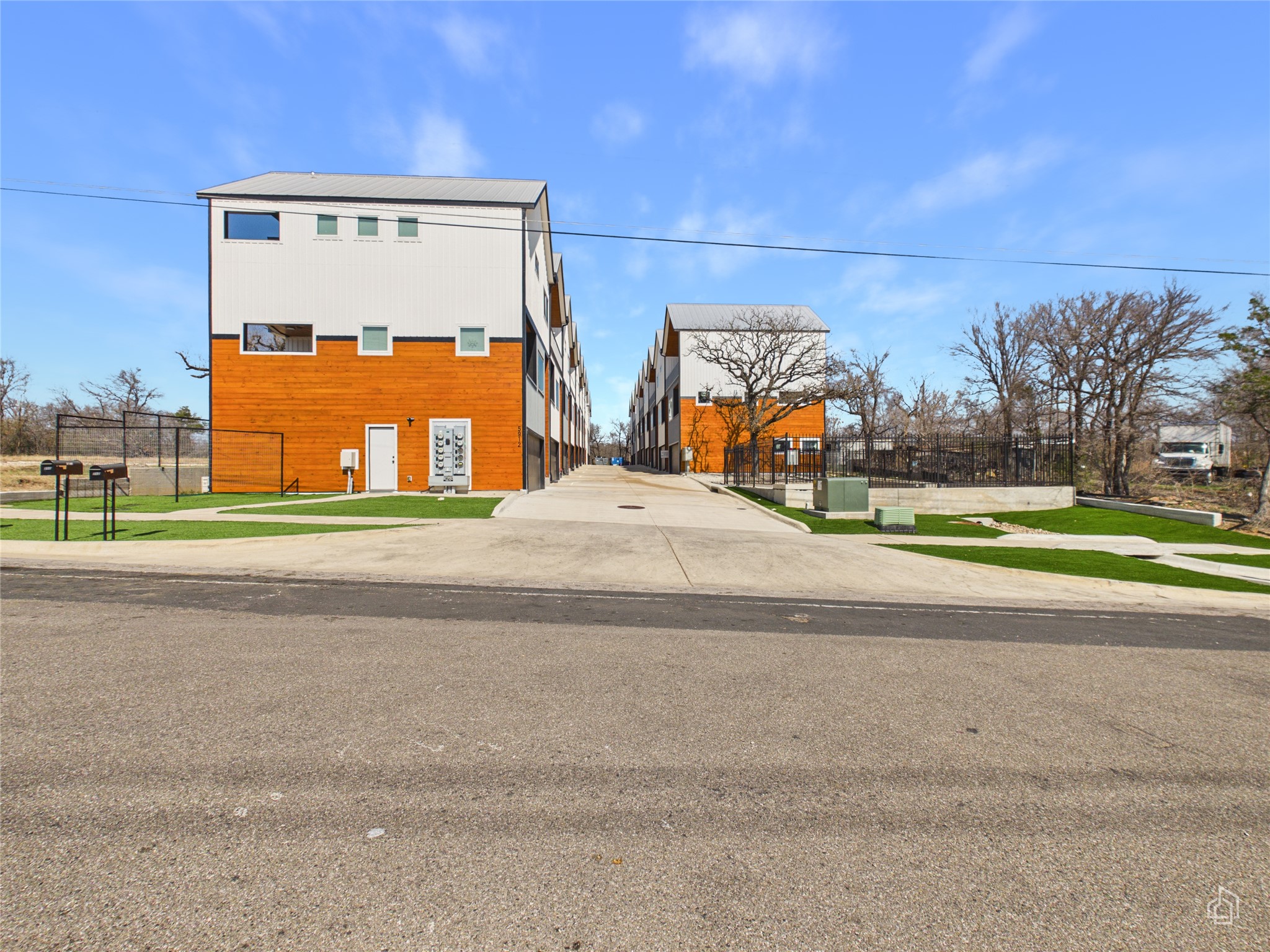 5912 Harold Court, Unit 105 Austin, TX 78721 - Photo 28 of 32 a picture of a building with a yard and balcony