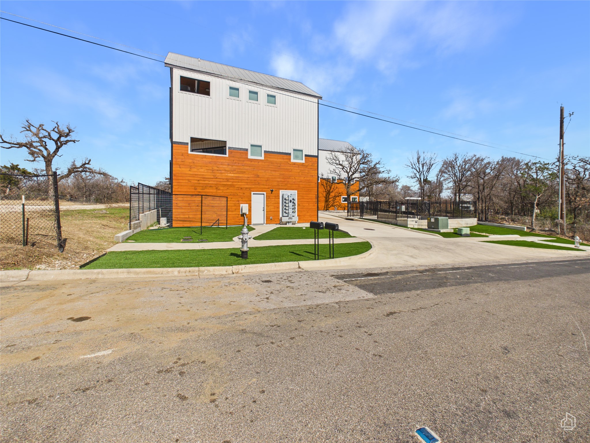 5912 Harold Court, Unit 105 Austin, TX 78721 - Photo 29 of 32 a view of a house with a big yard and palm trees