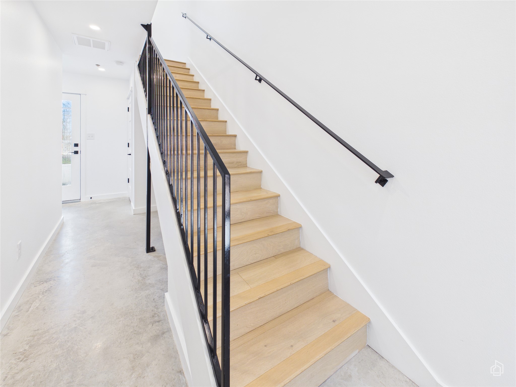 5912 Harold Court, Unit 105 Austin, TX 78721 - Photo 3 of 32 a view of staircase with white walls and railing