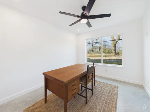 a workspace with wooden floor and a window