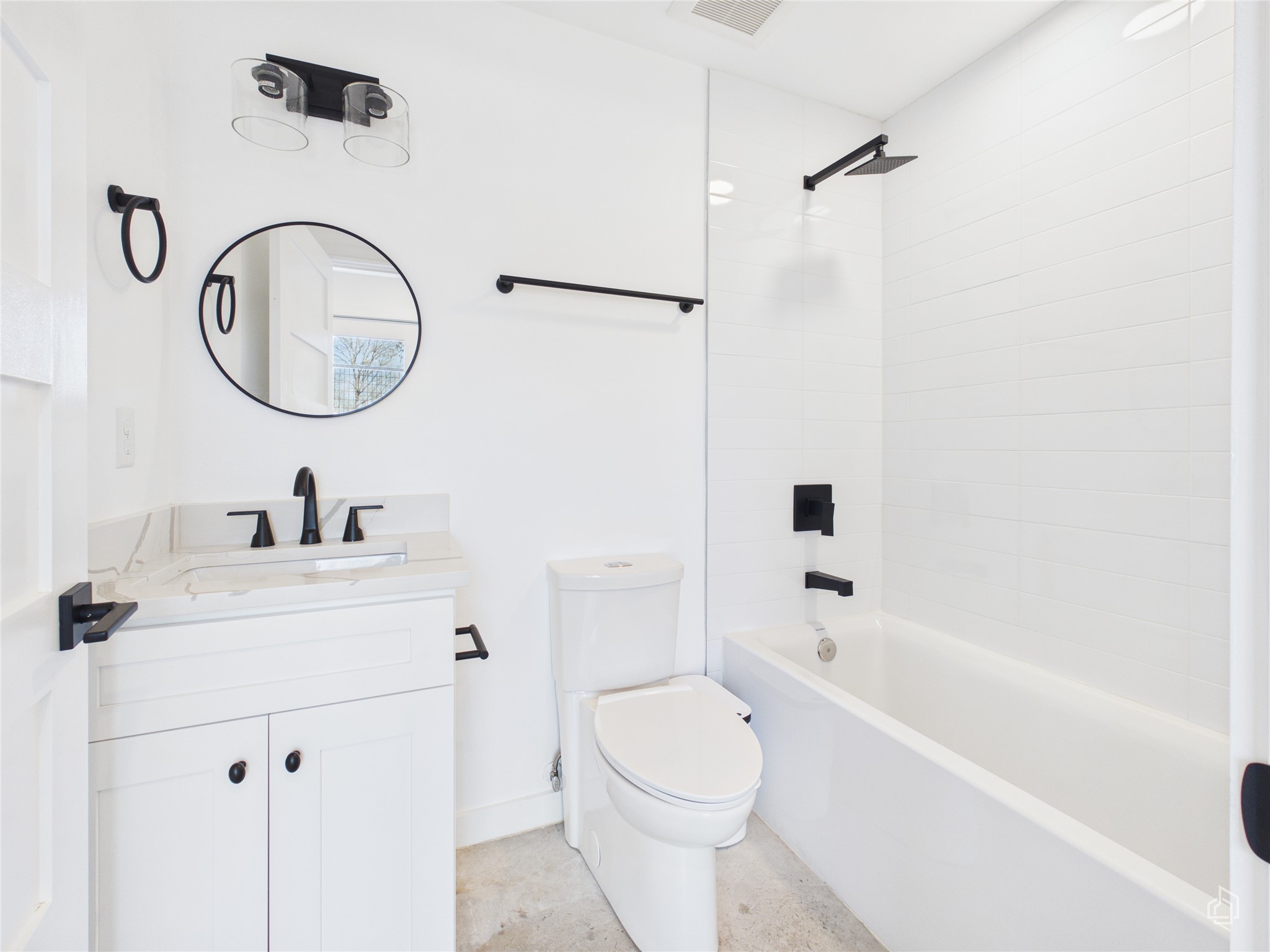 5912 Harold Court, Unit 105 Austin, TX 78721 - Photo 10 of 32 a bathroom with a sink a toilet and a mirror