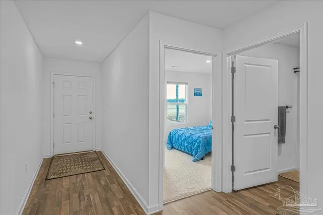 a view of a hallway view with wooden floor and staircase