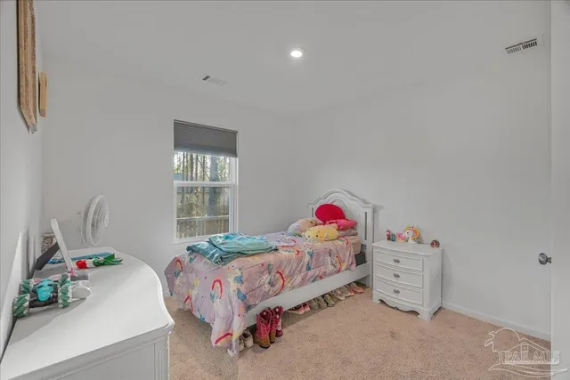 a bedroom with a bed and hallway