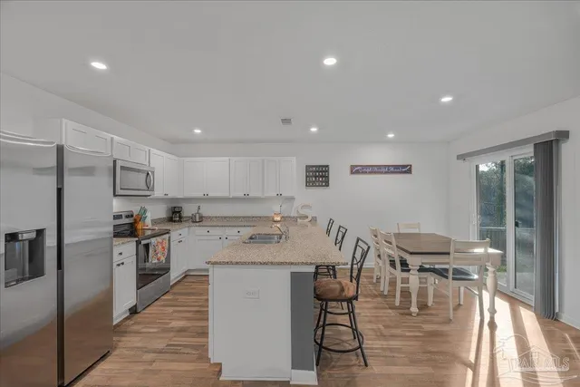 a living room with furniture a dining table and a window