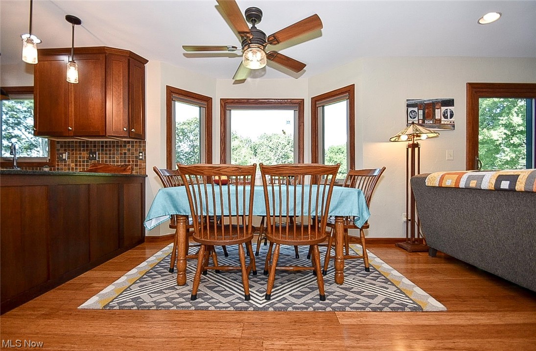 781 Yager Road Clinton, OH 44216 - Photo 20 of 34 Wood floored dining space with ceiling fan