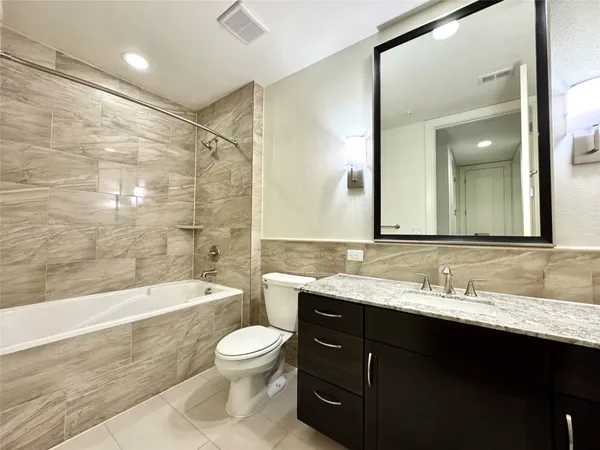 a bathroom with a sink a toilet and bathtub