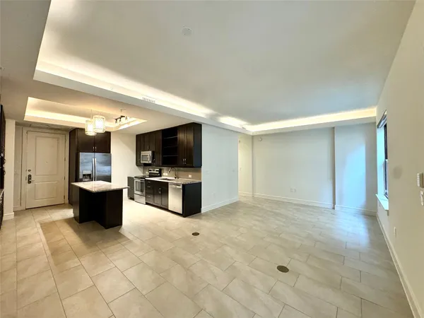 a view of a living room kitchen and a flat screen tv