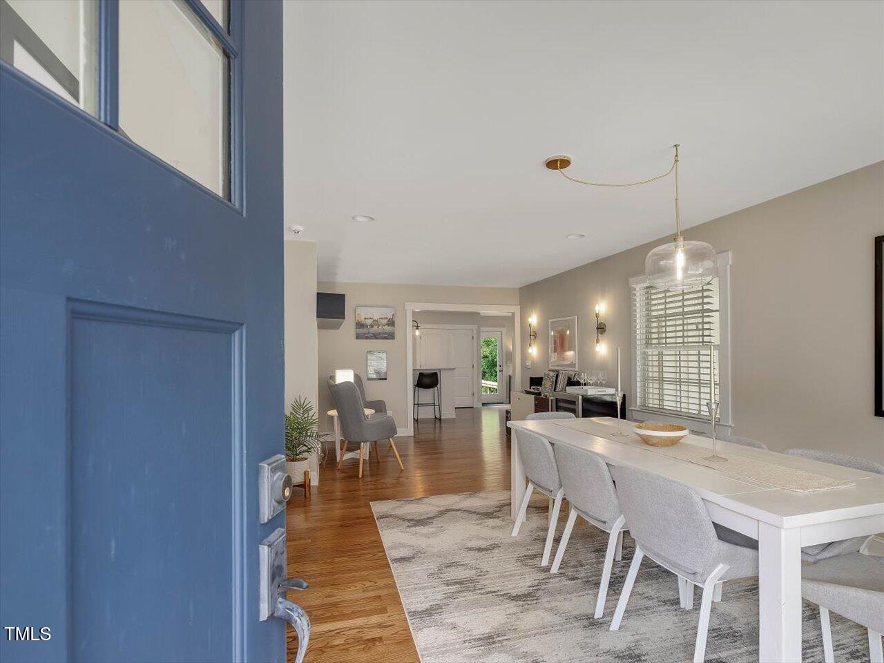 1310 Carolina Pines Avenue Raleigh, NC 27603 - Photo 11 of 53 a dining hall with stainless steel appliances kitchen island granite countertop a dining table chairs and granite counter tops