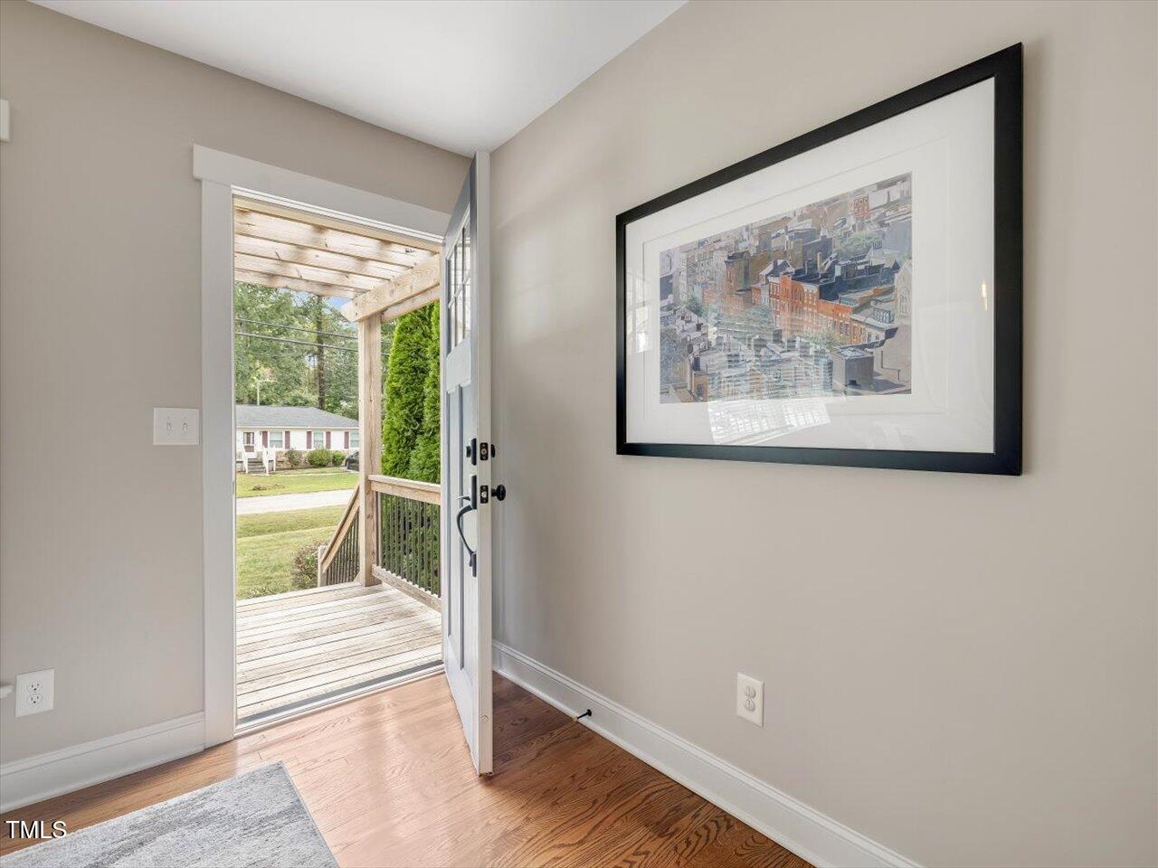 1310 Carolina Pines Avenue Raleigh, NC 27603 - Photo 12 of 53 a view of an empty room with wooden floor and a window