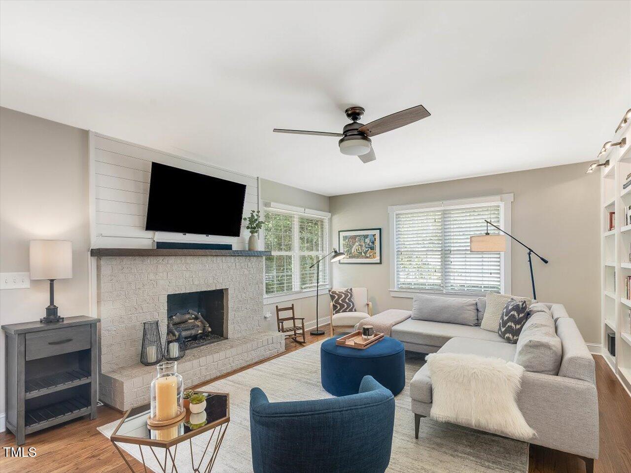 1310 Carolina Pines Avenue Raleigh, NC 27603 - Photo 22 of 53 a living room with furniture a fireplace and a flat screen tv